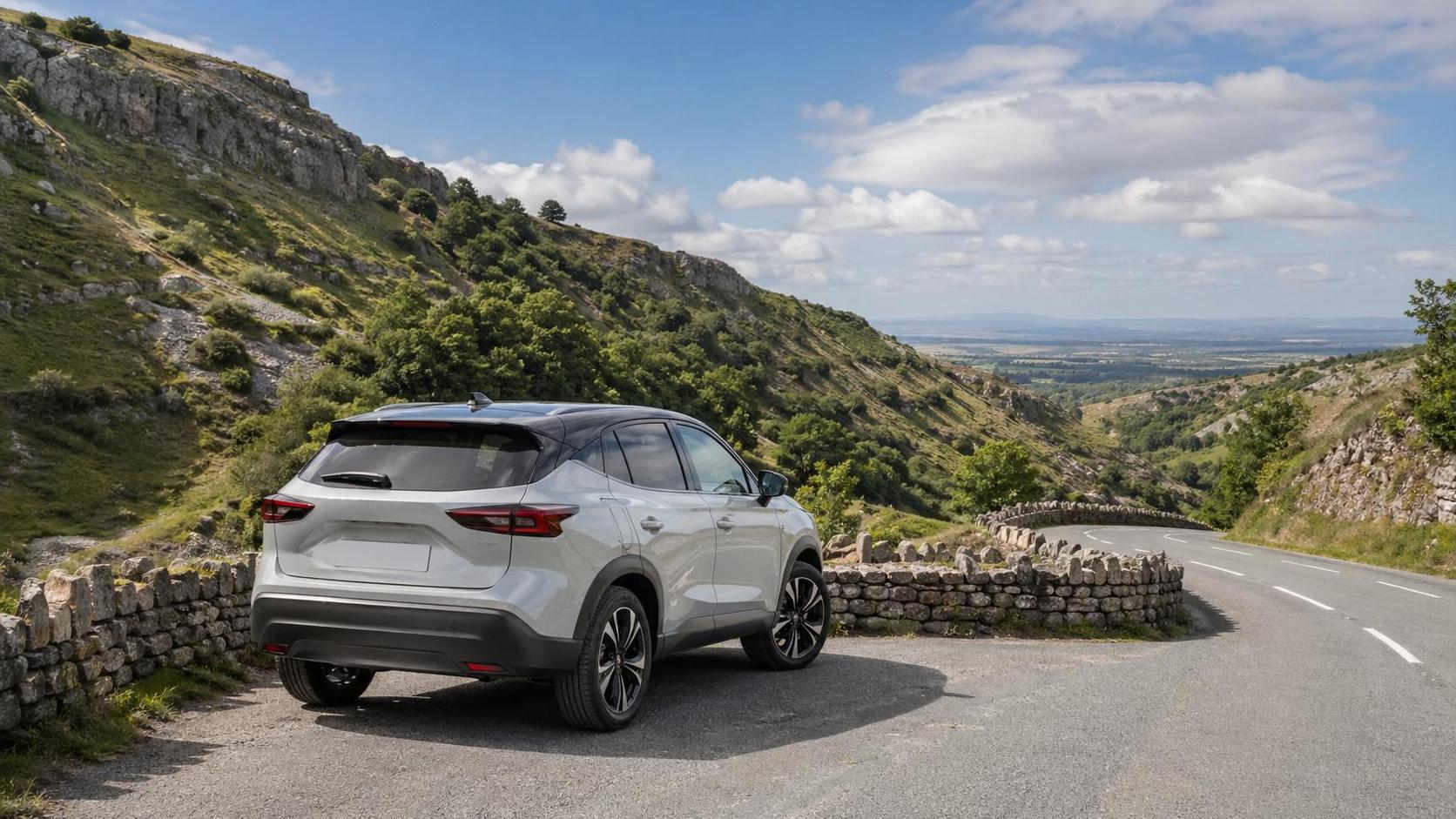 Rental crossover at a scenic roadside stop near Cheddar with green hills and stone walls